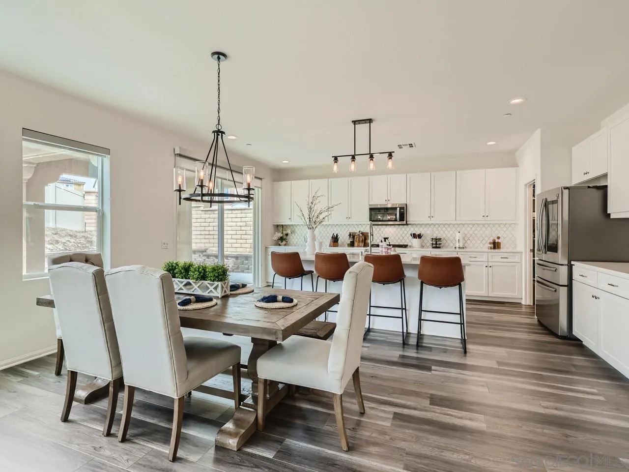 1263 Spivey Road Chula Vista, CA 91913 - Photo 9 of 26 a view of a dining room and livingroom with furniture wooden floor a chandelier