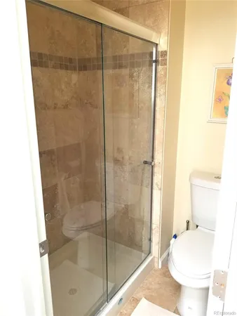 a bathroom with a shower and a toilet sink