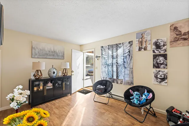 a living room with furniture and a floor to ceiling window