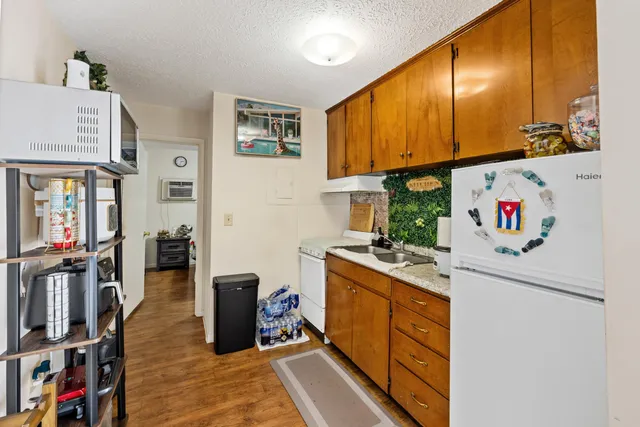 a kitchen that has a lot of cabinets a sink and a stove in it