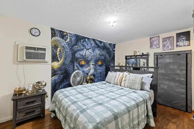 a bedroom with a bed and wooden floor