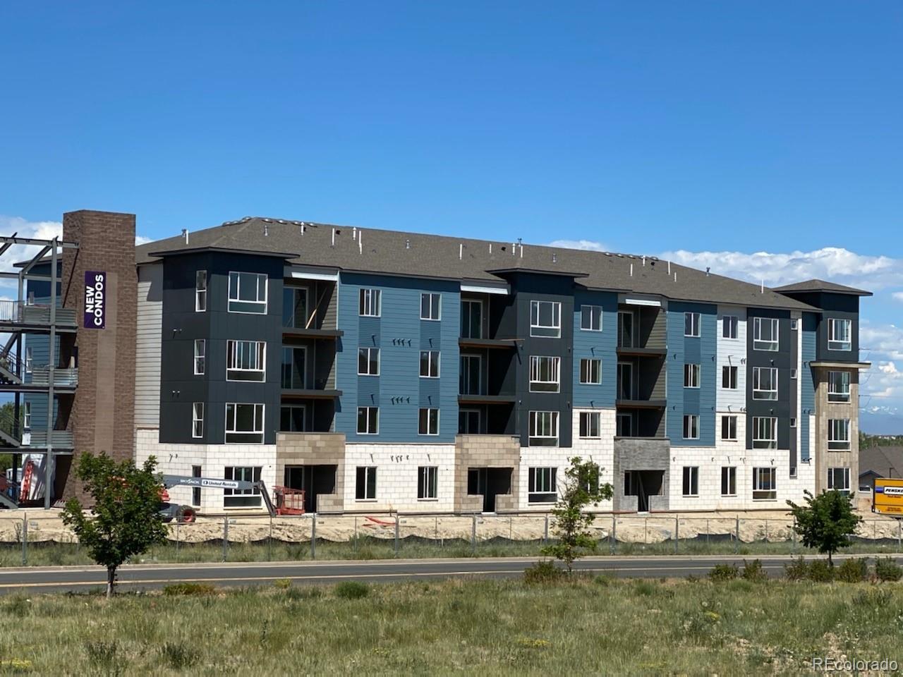 9287 Twenty Mile Road, Unit 301 Parker, CO 80134 - Photo 1 of 3 front view of house with a yard