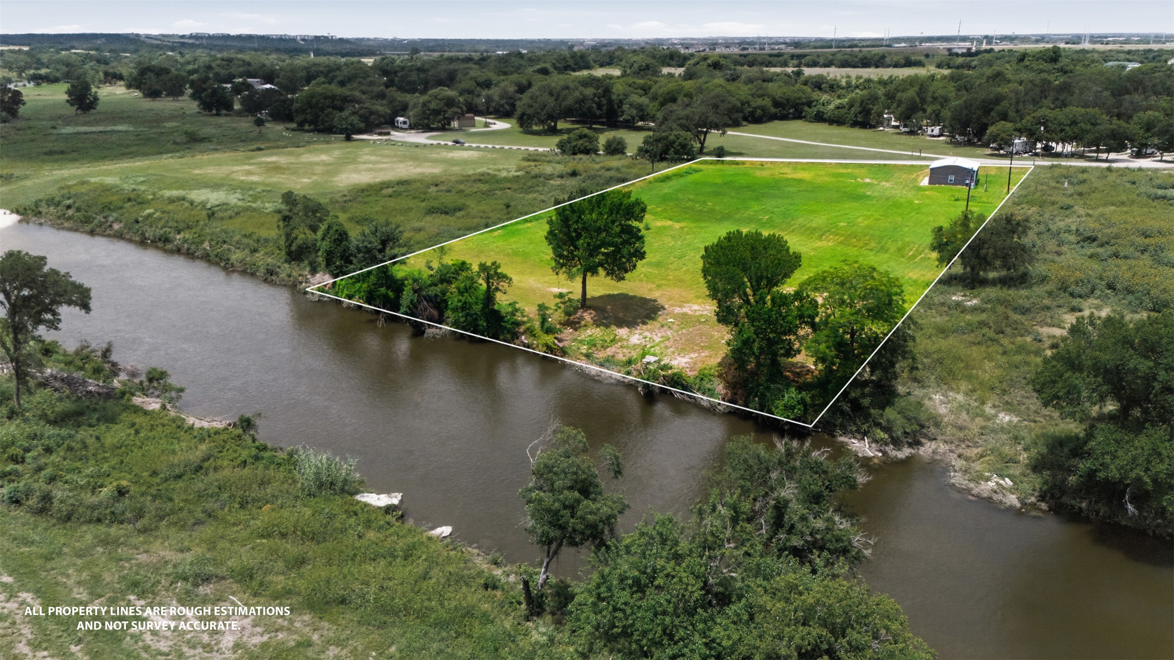 2043 Fm 971 Georgetown, TX 78626 - Photo 11 of 12 A tranquil riverfront lot offers serene views and ample space for a dream home.