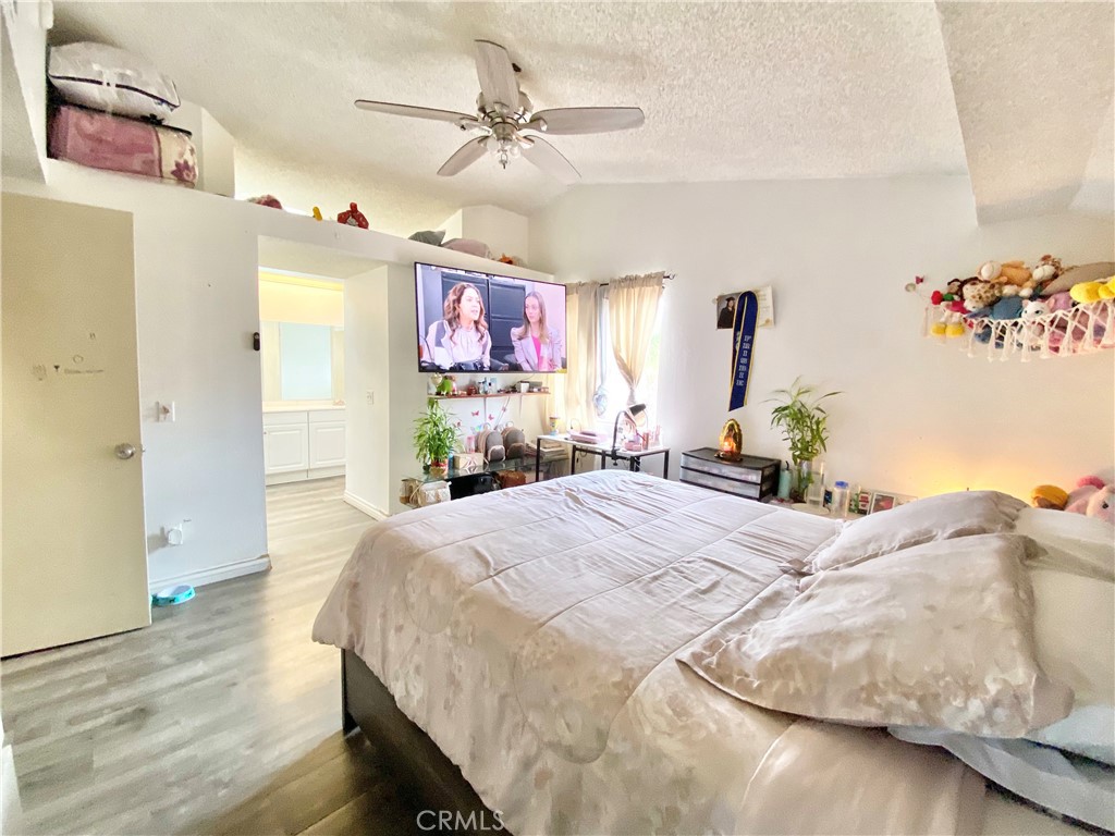 1444 North Sage Avenue Rialto, CA 92376 - Photo 17 of 22 a bedroom with a bed and a chandelier