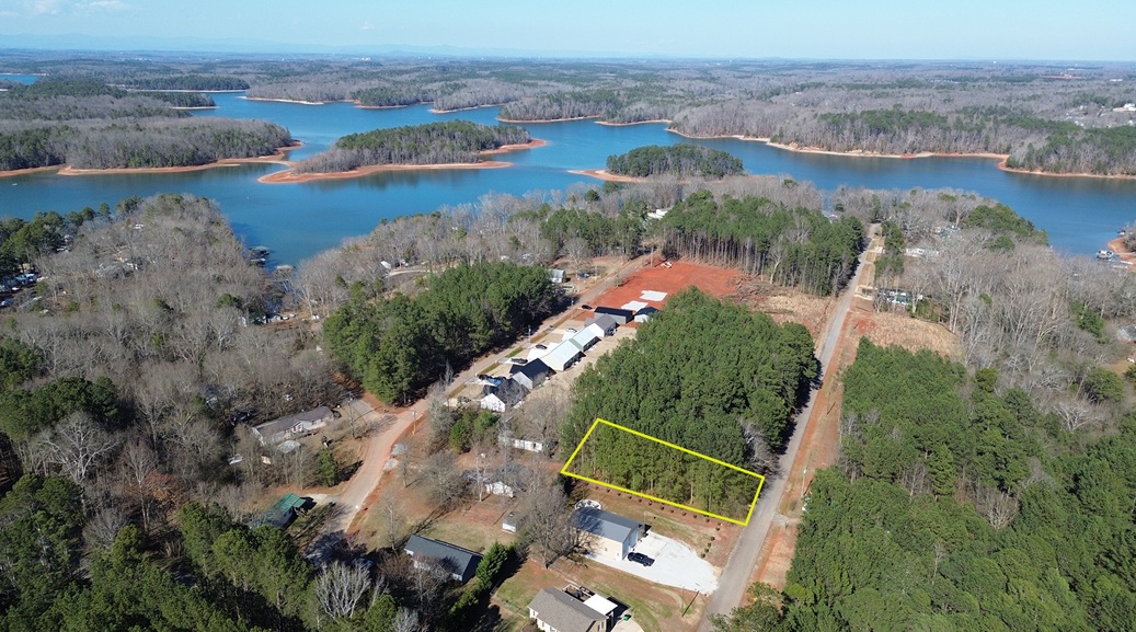 Lot 107 Robinhood Road Townville, SC 29689 - Photo 1 of 3 This serene aerial view captures a tranquil lake surrounded by lush woodland, offering peaceful living.