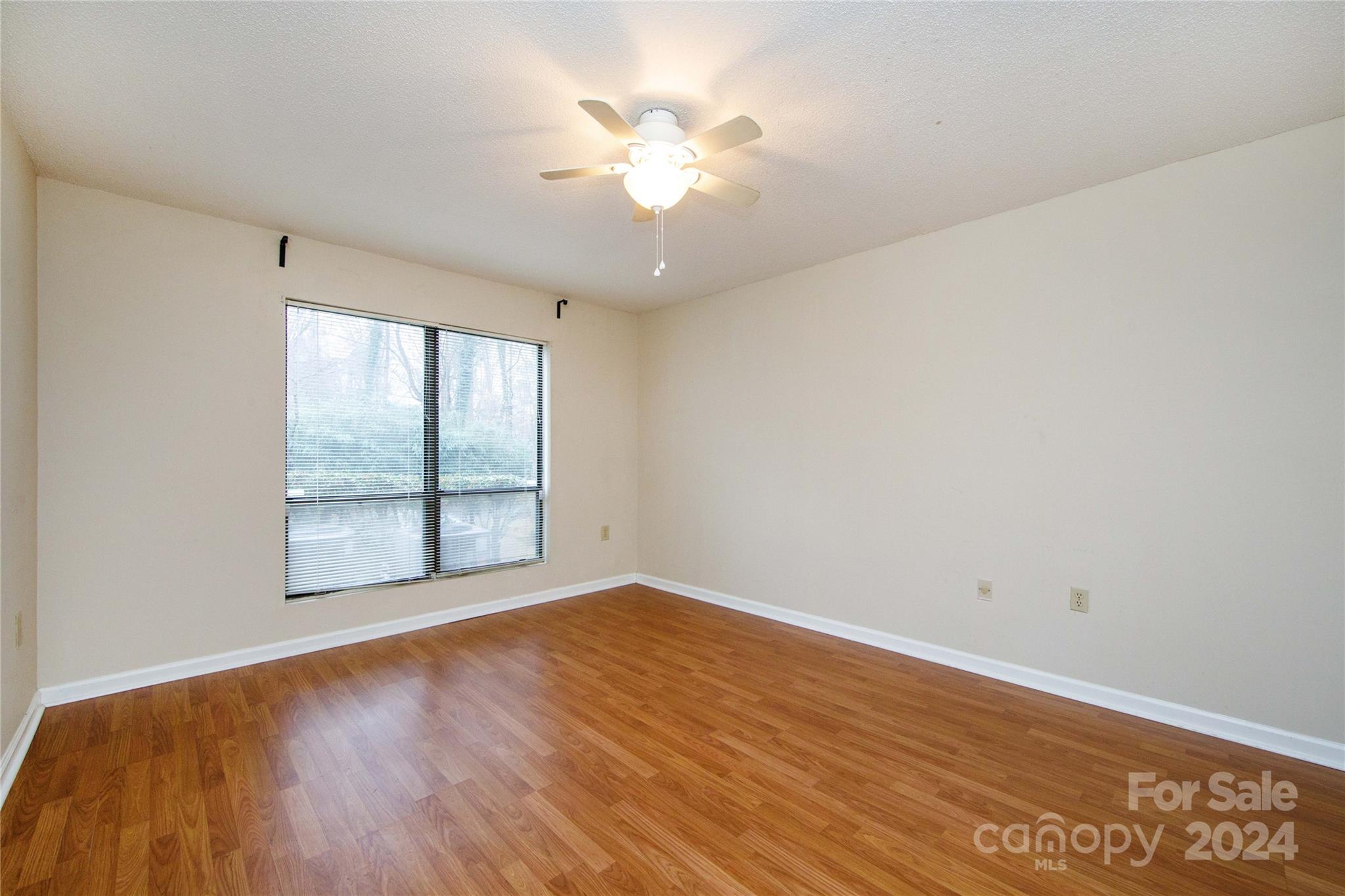 5020 Sardis Road, Unit E Charlotte, NC 28270 - Photo 17 of 27 wooden floor in an empty room with a window