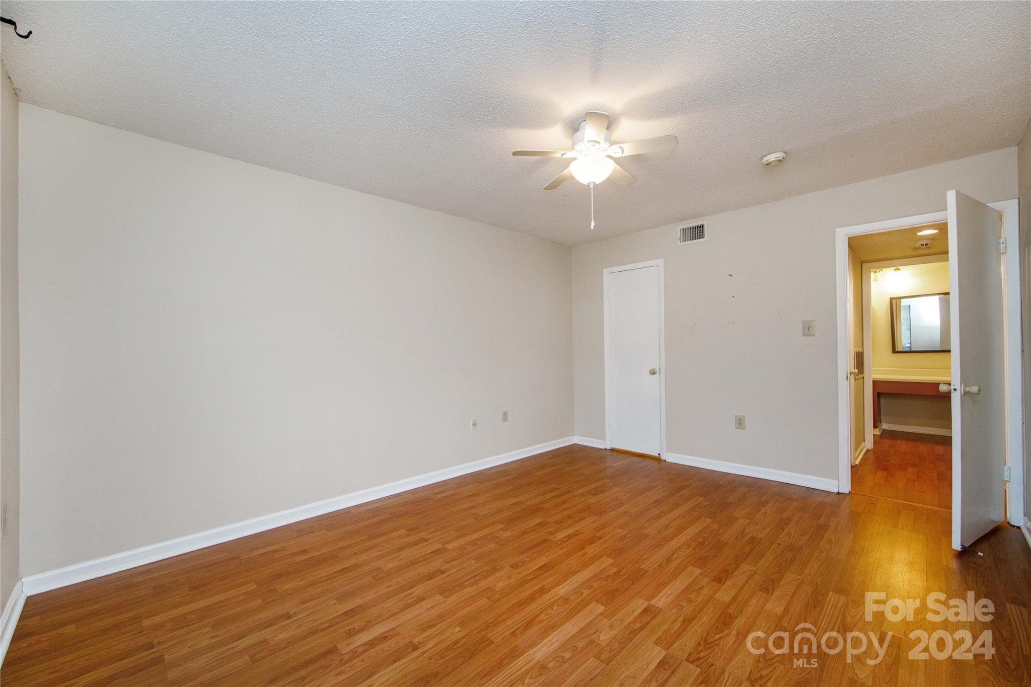 5020 Sardis Road, Unit E Charlotte, NC 28270 - Photo 18 of 27 a view of an empty room with wooden floor