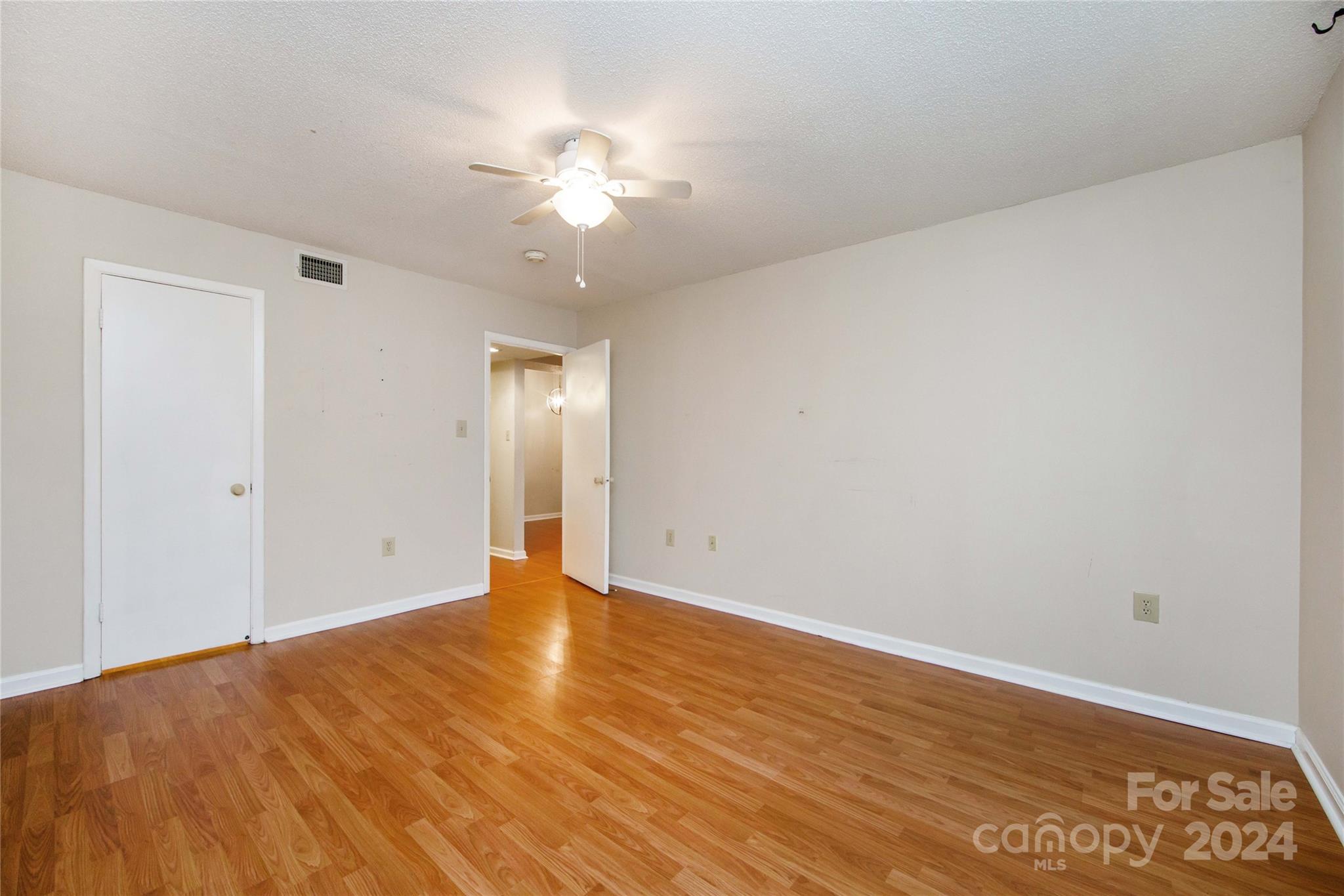 5020 Sardis Road, Unit E Charlotte, NC 28270 - Photo 19 of 27 a view of an empty room with wooden floor