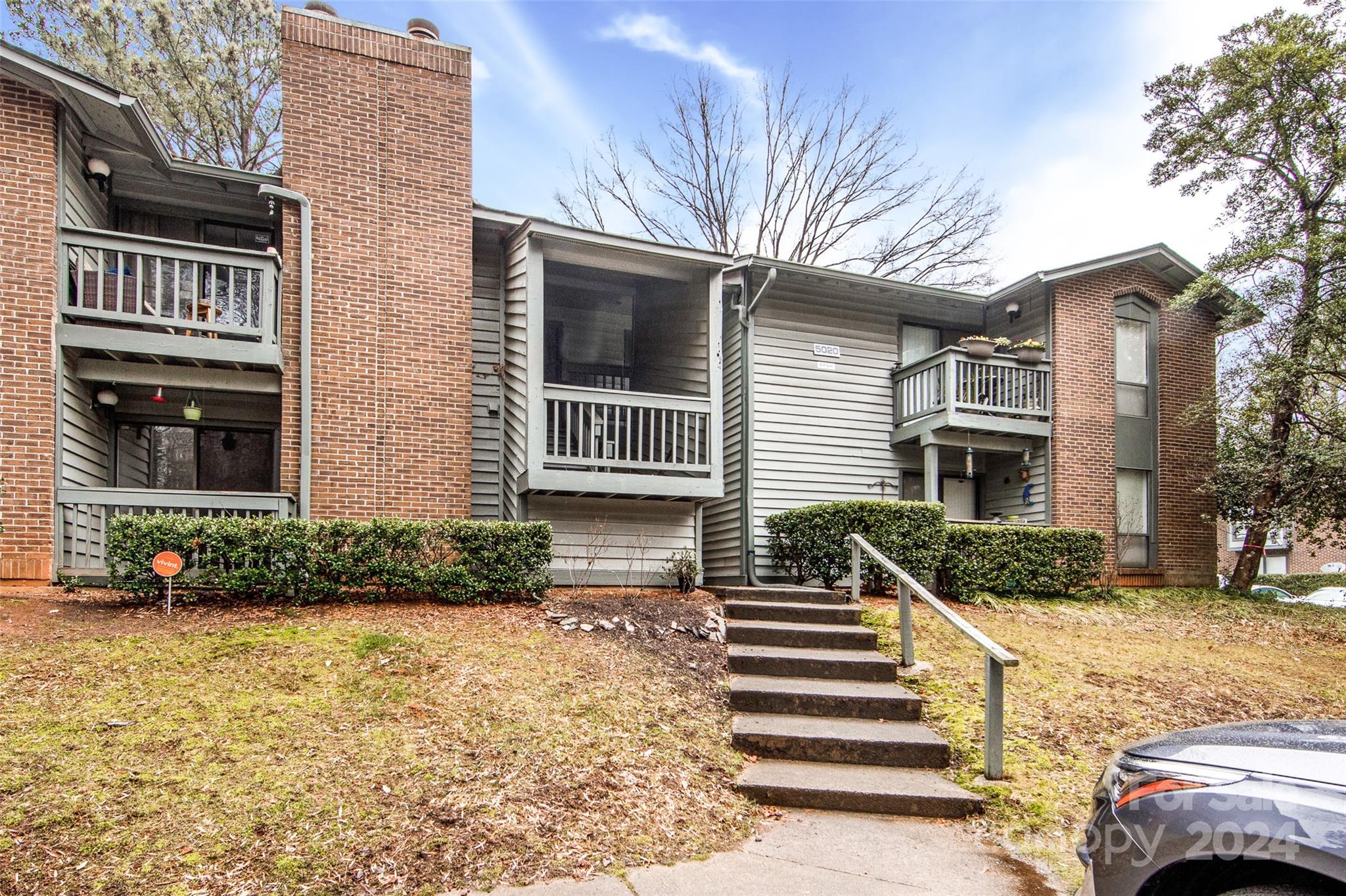 5020 Sardis Road, Unit E Charlotte, NC 28270 - Photo 2 of 27 a front view of a house with a yard
