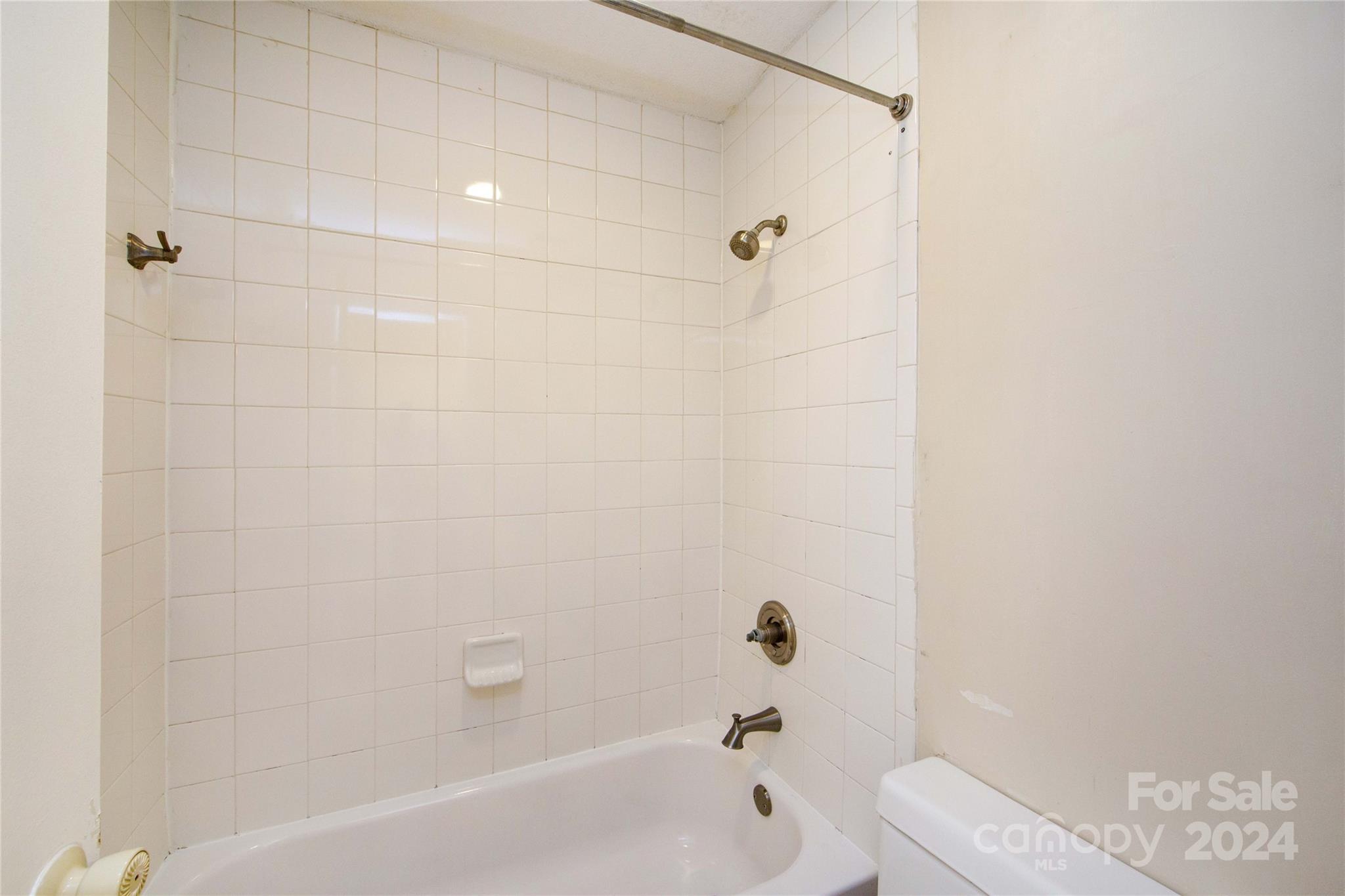 5020 Sardis Road, Unit E Charlotte, NC 28270 - Photo 22 of 27 a bathroom with a bathtub and a shower