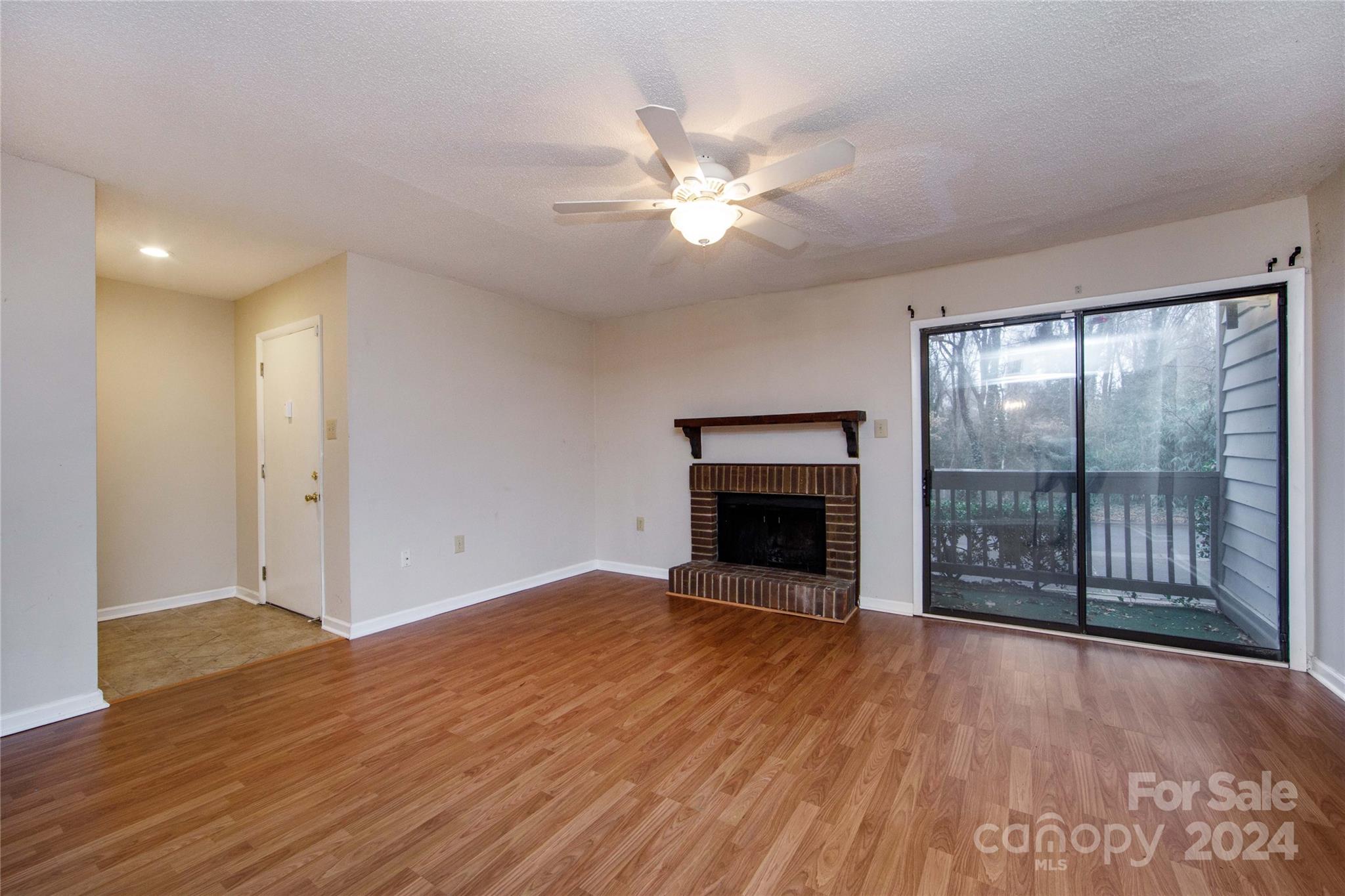 5020 Sardis Road, Unit E Charlotte, NC 28270 - Photo 3 of 27 a view of an empty room with wooden floor and a window