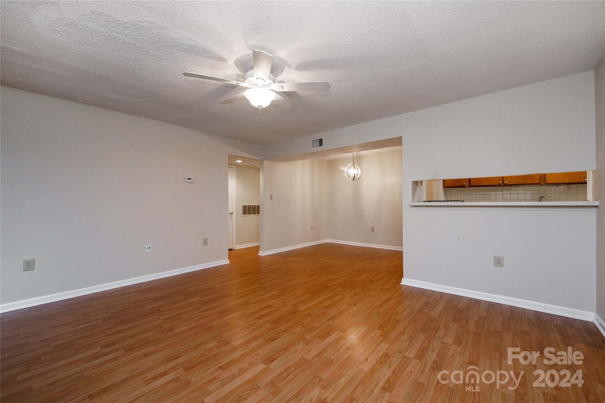 5020 Sardis Road, Unit E Charlotte, NC 28270 - Photo 5 of 27 a view of an empty room and wooden floor