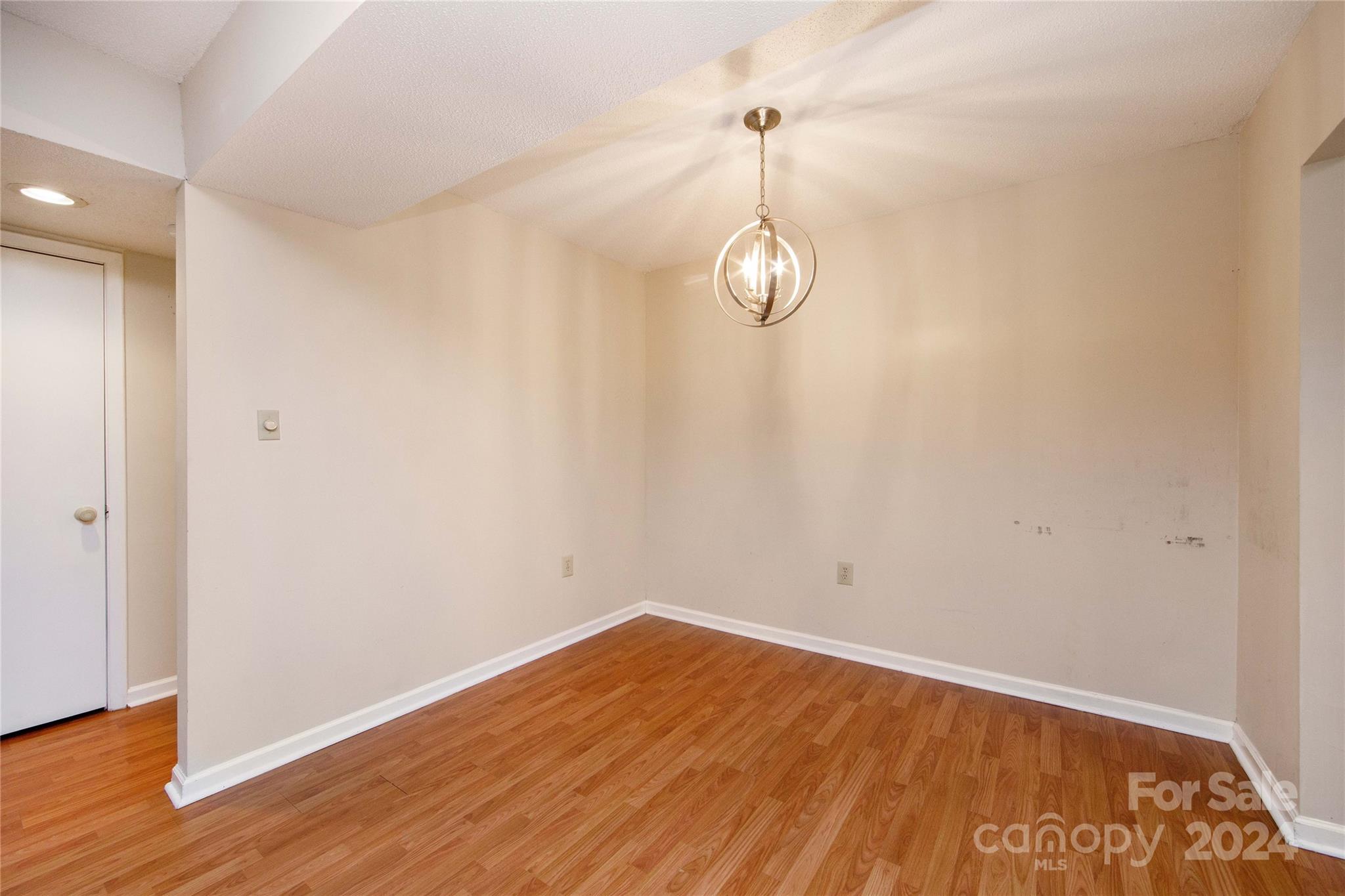 5020 Sardis Road, Unit E Charlotte, NC 28270 - Photo 8 of 27 a view of empty room with wooden floor