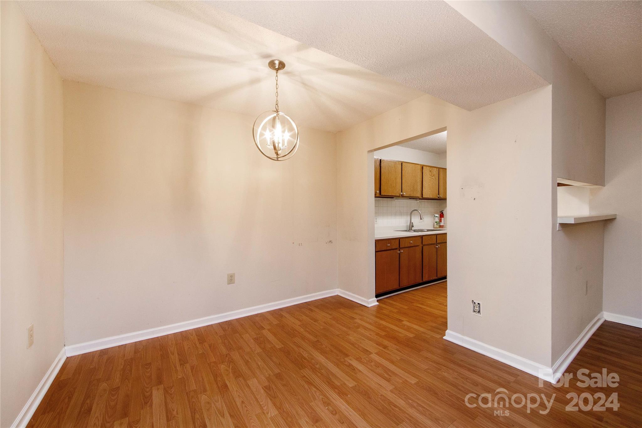5020 Sardis Road, Unit E Charlotte, NC 28270 - Photo 9 of 27 a view of a kitchen with a dishwasher cabinets and wooden floor