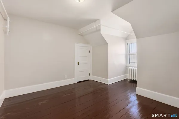 an empty room with wooden floor