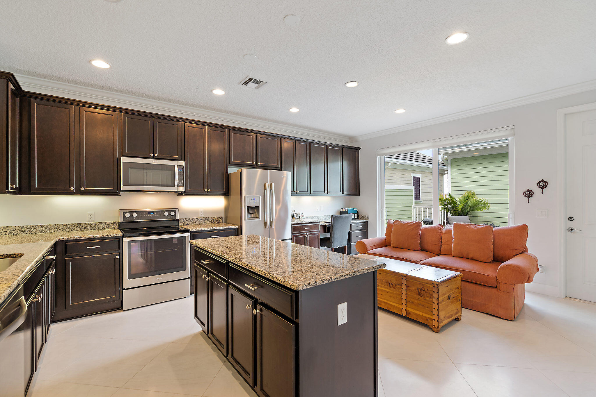 1237 Dakota Drive Jupiter, FL 33458 - Photo 11 of 32 a kitchen with stainless steel appliances granite countertop a refrigerator a sink dishwasher a stove and a refrigerator with wooden floor