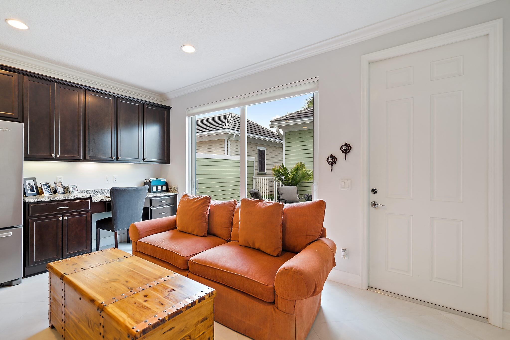 1237 Dakota Drive Jupiter, FL 33458 - Photo 14 of 32 a kitchen with stainless steel appliances granite countertop a refrigerator a stove top oven a sink with dishwasher and wooden cabinets