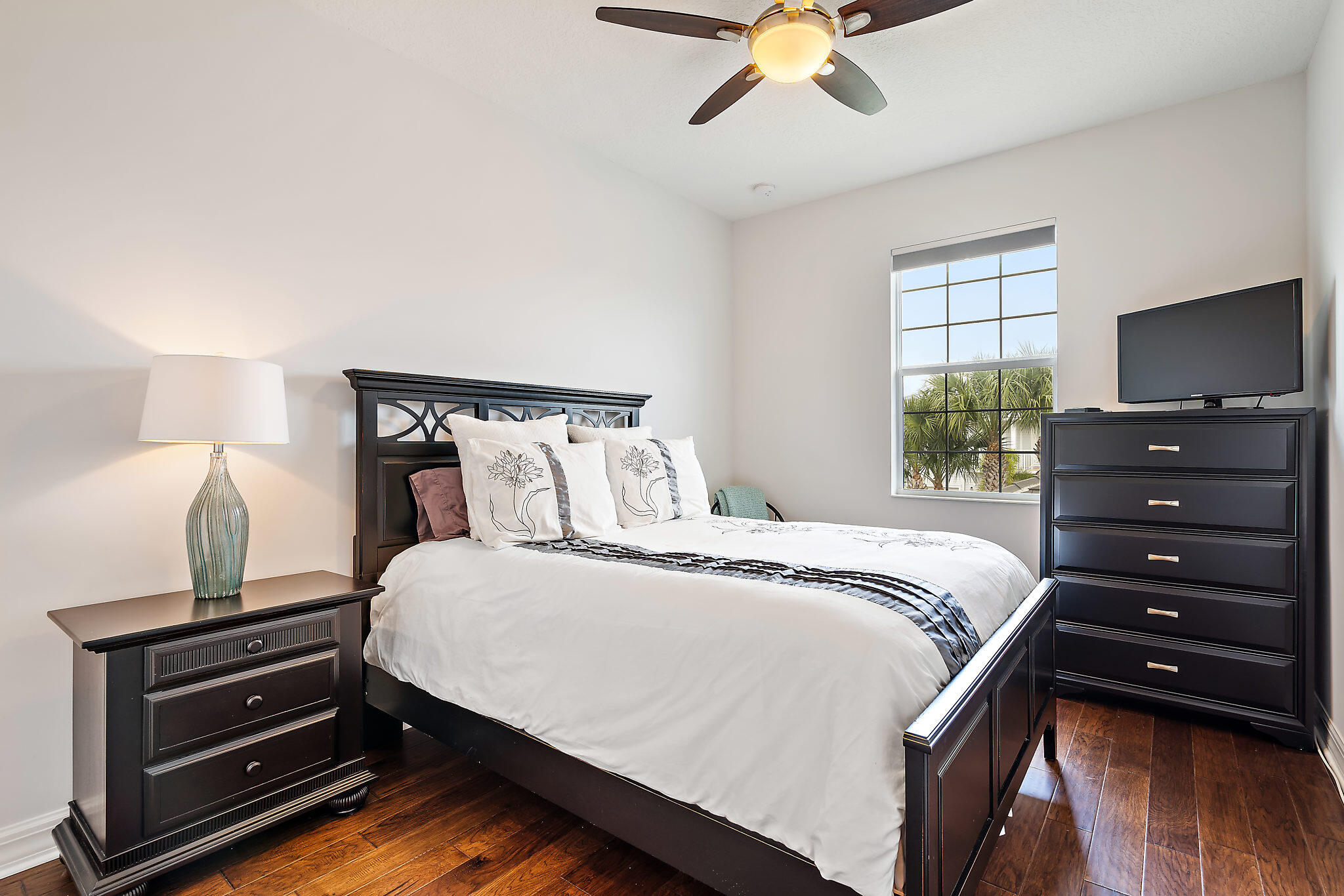 1237 Dakota Drive Jupiter, FL 33458 - Photo 22 of 32 a bedroom with a bed and a tv