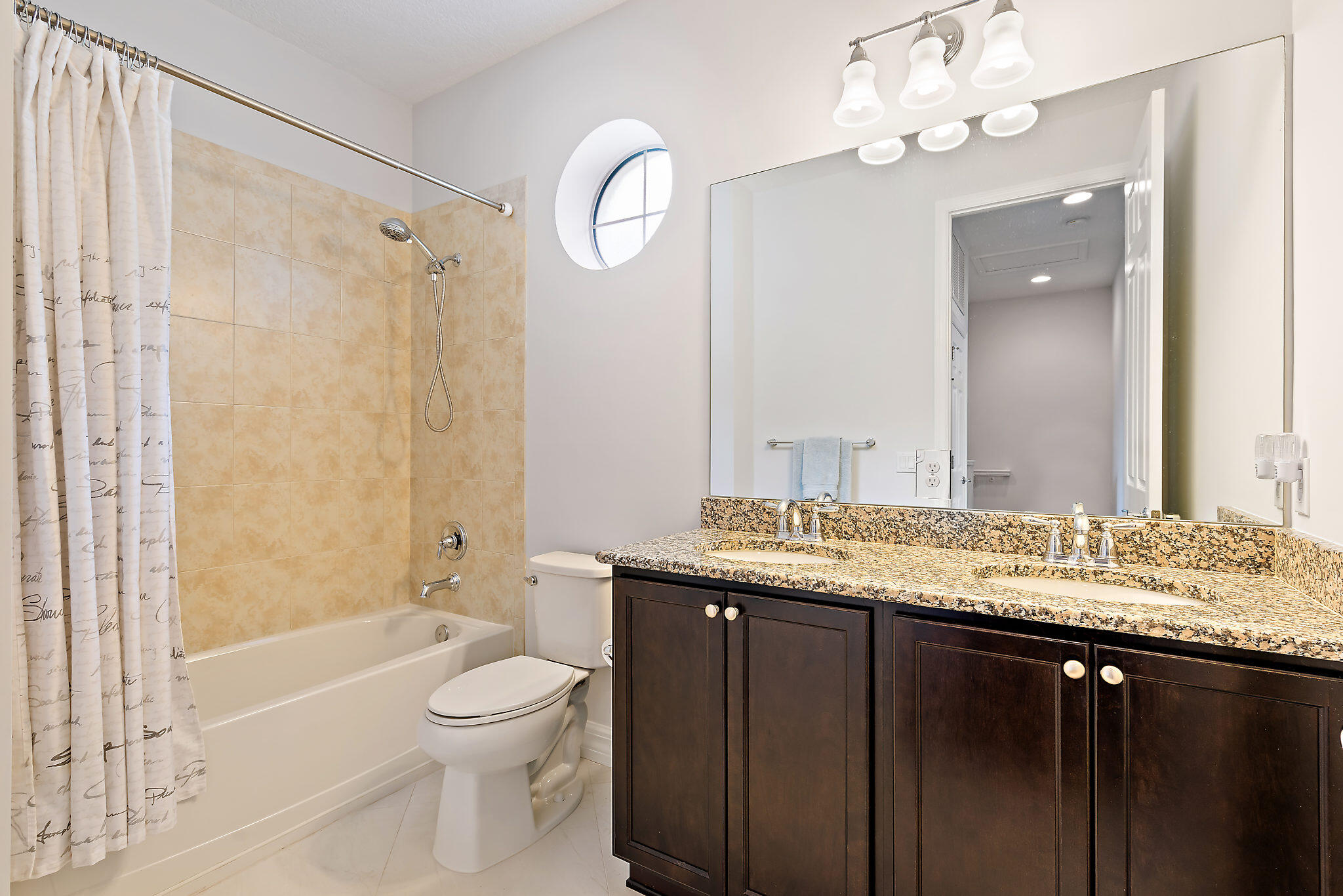1237 Dakota Drive Jupiter, FL 33458 - Photo 23 of 32 a bathroom with a granite countertop sink a toilet and a bathtub