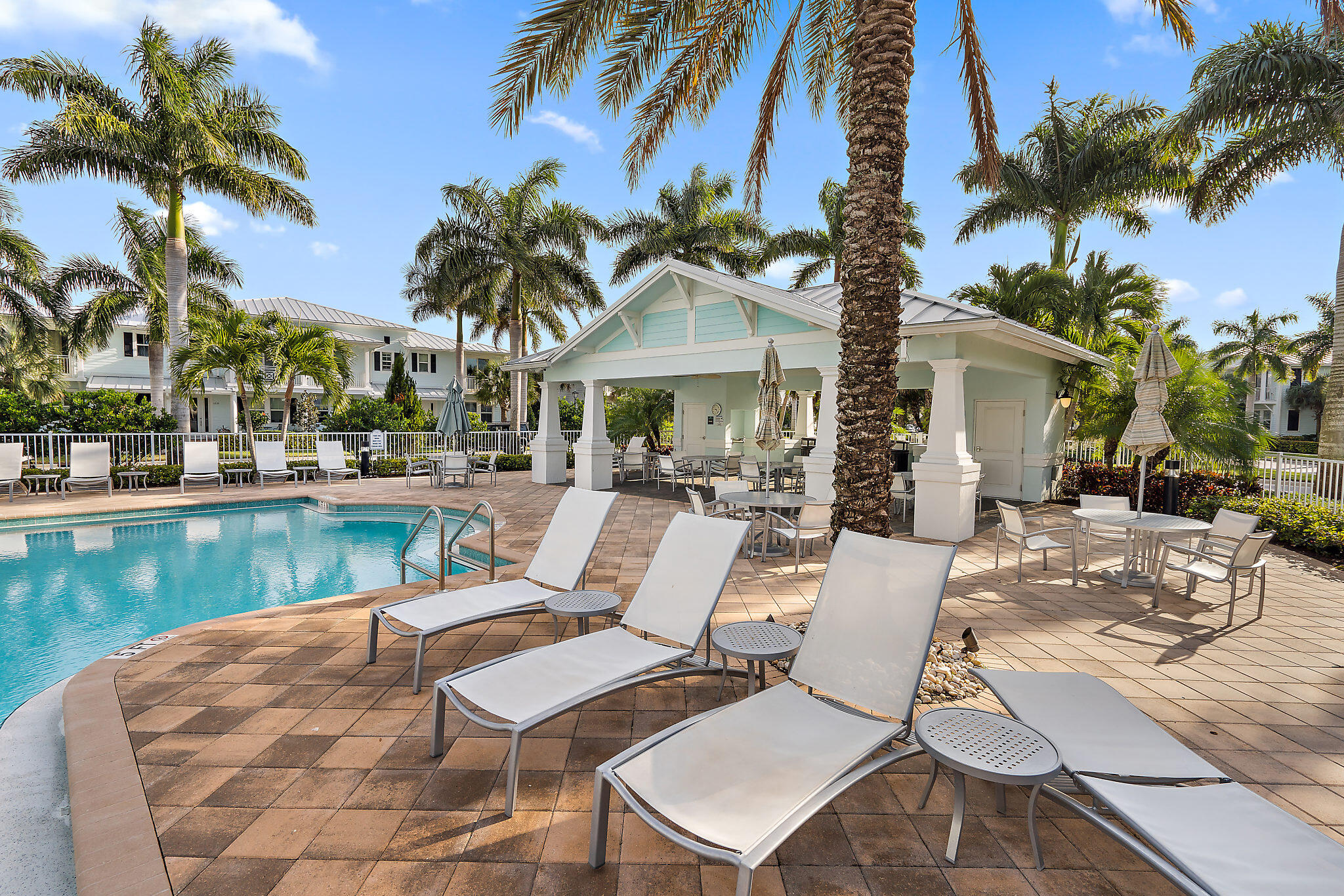 1237 Dakota Drive Jupiter, FL 33458 - Photo 30 of 32 a view of a patio with swimming pool table and chairs