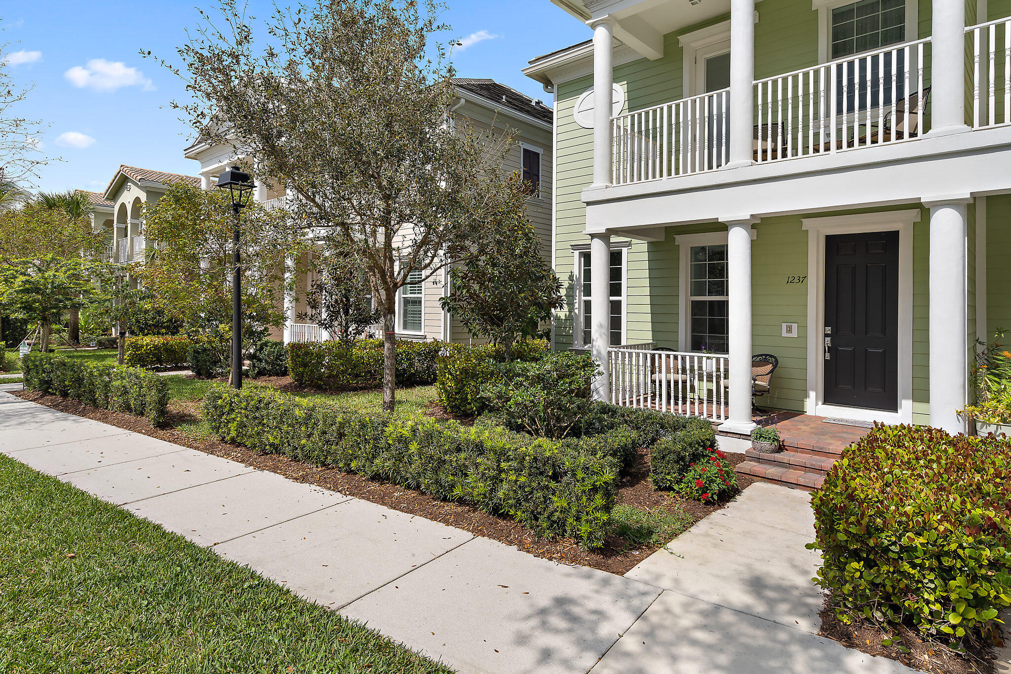1237 Dakota Drive Jupiter, FL 33458 - Photo 4 of 32 a front view of a house with garden