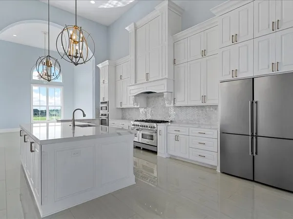 a kitchen with white cabinets and white appliances