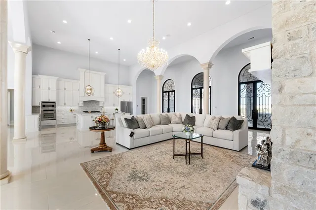 a view of a dining room with furniture and chandelier
