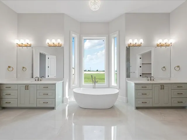 a view of a kitchen with a sink and dishwasher a refrigerator with white cabinets
