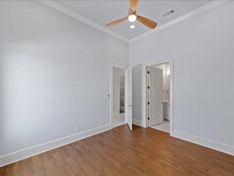 112 Yellow Rose Street Lorena, TX 76655 - Photo 27 of 42 an empty room with wooden floor a ceiling fan and windows