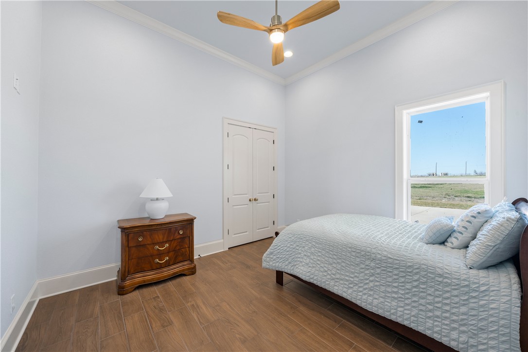 112 Yellow Rose Street Lorena, TX 76655 - Photo 32 of 42 a bedroom with a bed and a chandelier