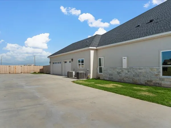 a view of a house with a yard and a garage