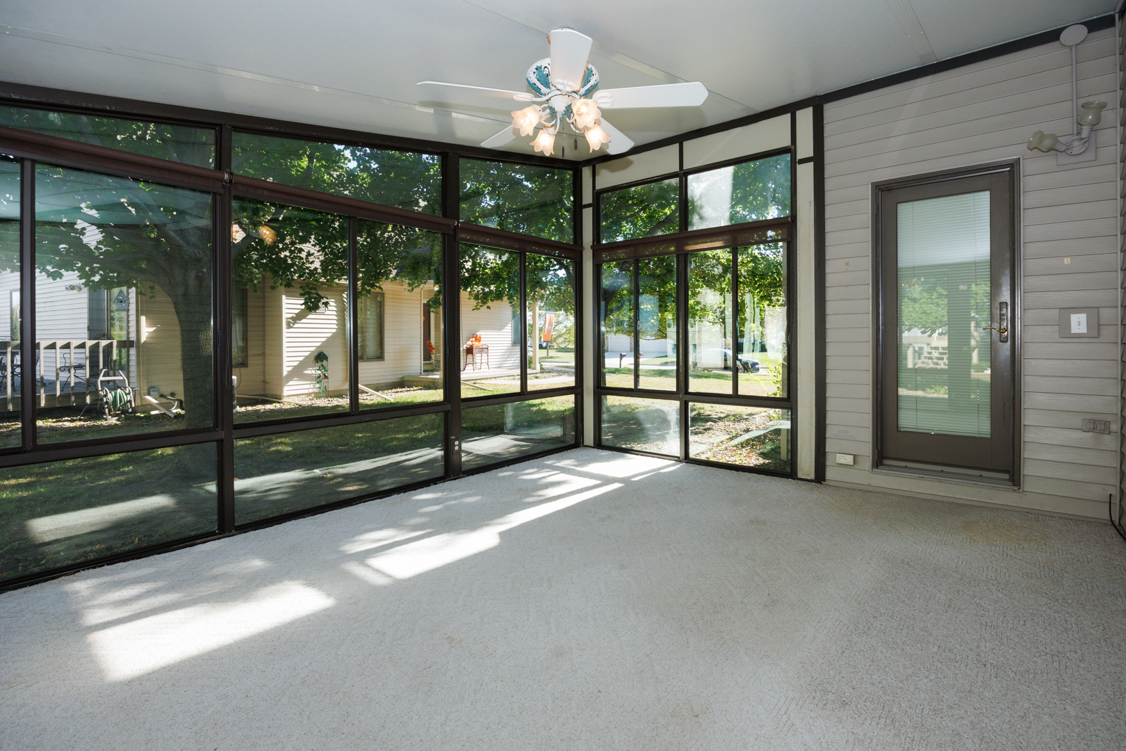 1414 B Tamarack Country Club Trail Normal, IL 61761 - Photo 12 of 48 a view of an empty room with windows and ceiling fan