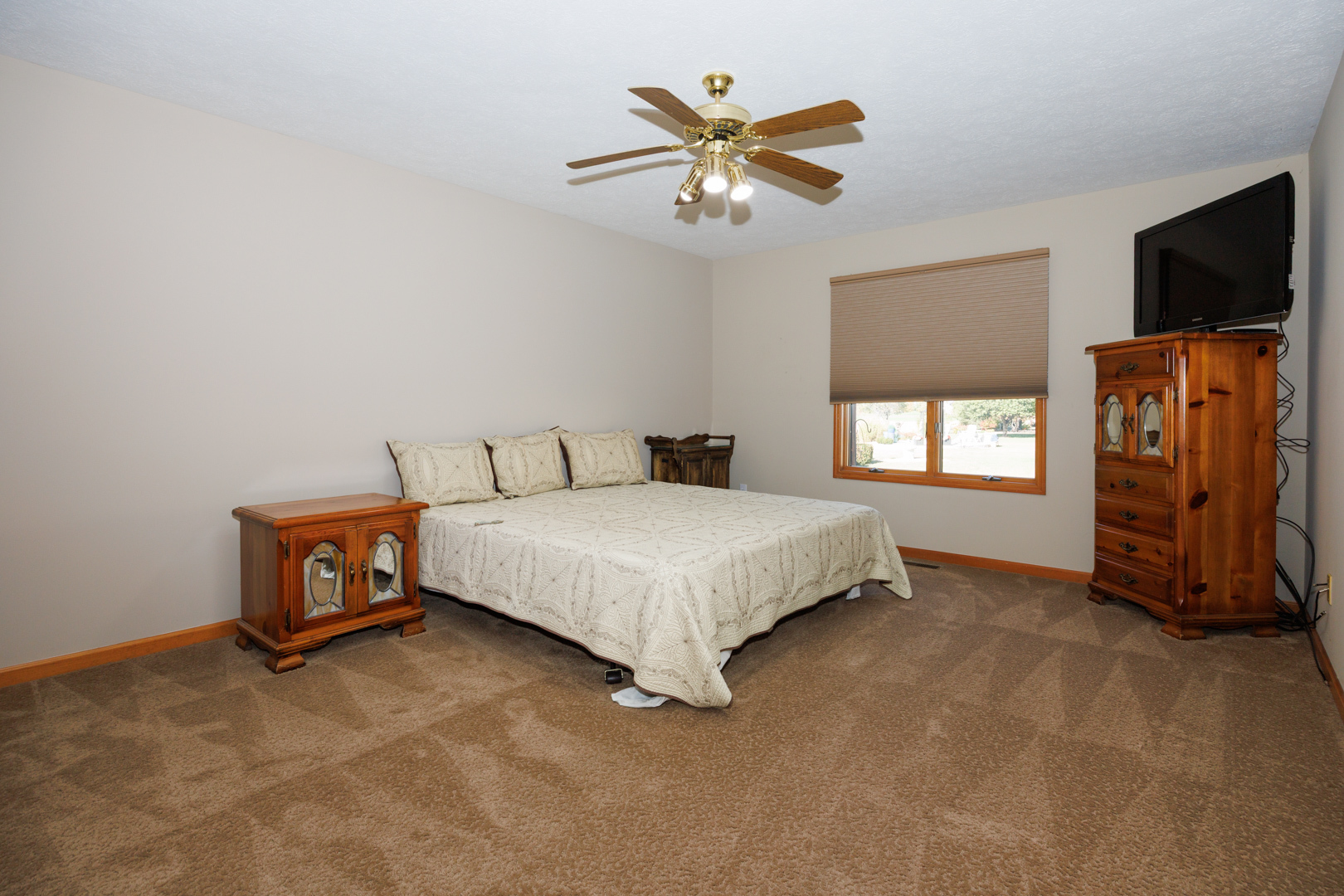 1414 B Tamarack Country Club Trail Normal, IL 61761 - Photo 21 of 48 a bedroom with a bed and a tv on the wall