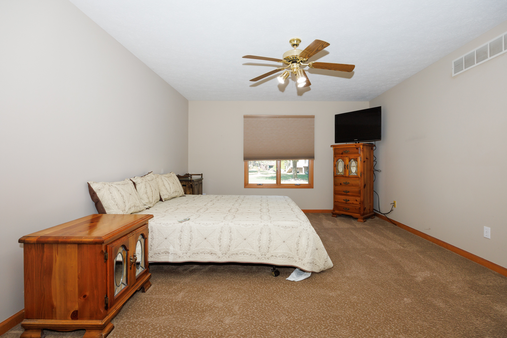 1414 B Tamarack Country Club Trail Normal, IL 61761 - Photo 22 of 48 a spacious bedroom with a bed and a chandelier