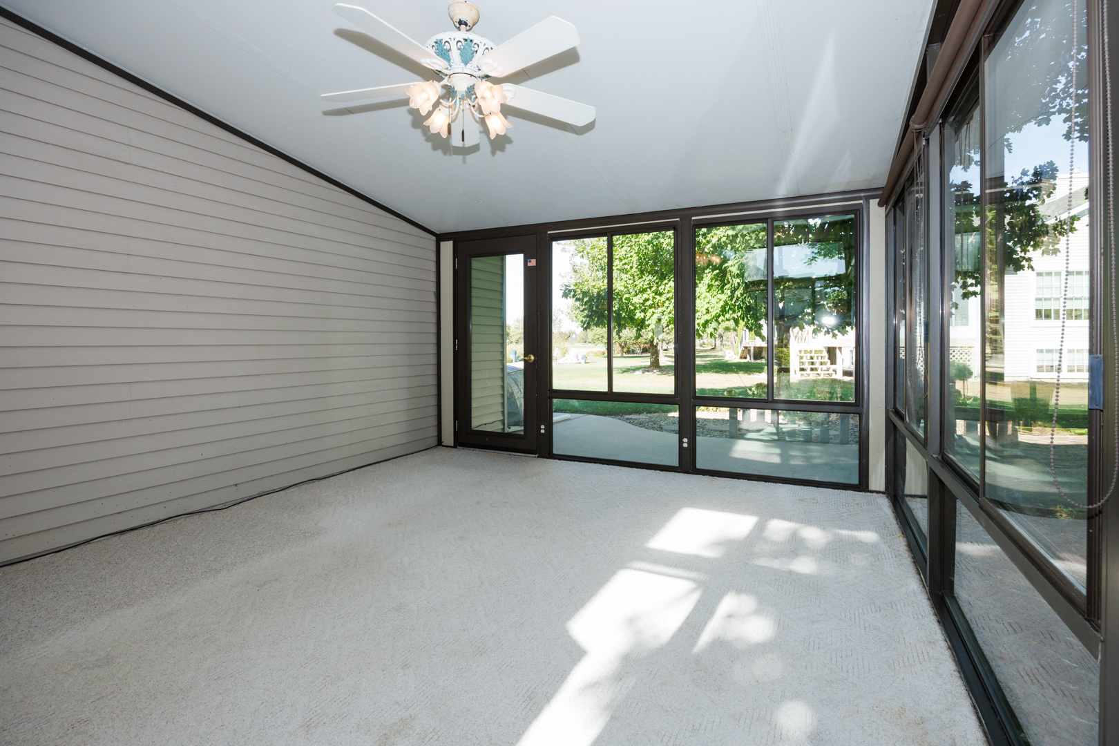 1414 B Tamarack Country Club Trail Normal, IL 61761 - Photo 10 of 48 a view of a livingroom with a fan and a large window