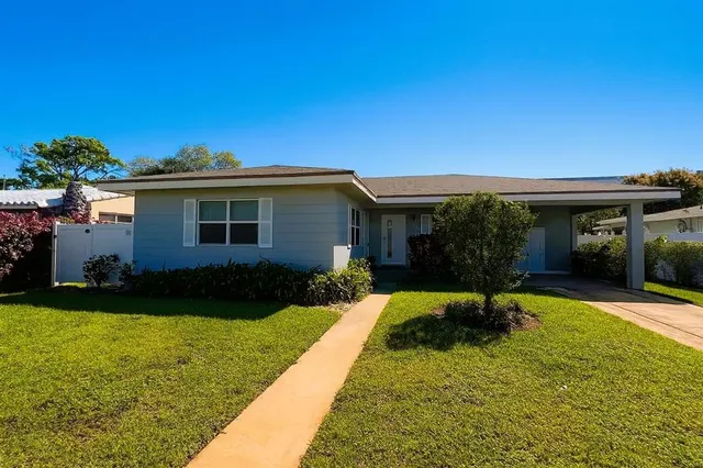 a view of a house with backyard sitting area and garden