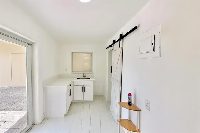 a bathroom with a bathtub sink mirror and toilet