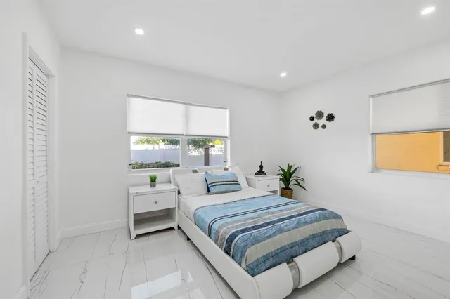 a bedroom with a bed and a window