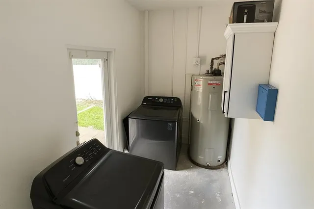a view of a house with a swimming pool and sitting area