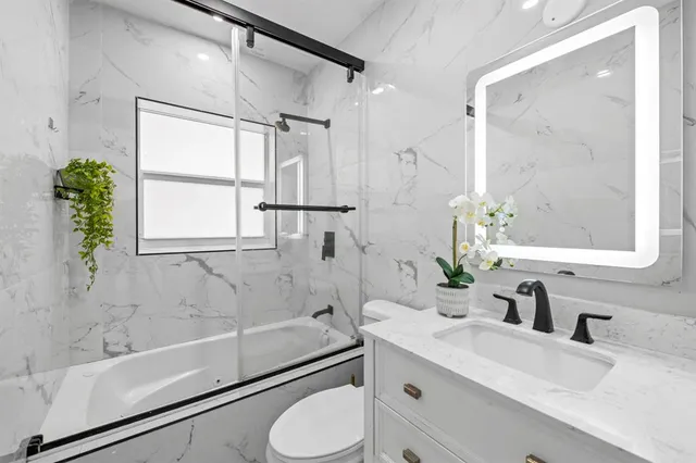 a bathroom with a sink toilet and shower