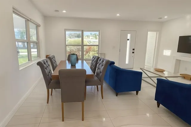 a view of a dining room with furniture window and outside view