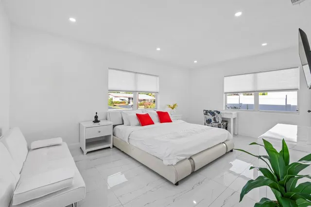 a bedroom with a bed and window