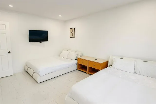 a bedroom with a bed and a flat screen tv