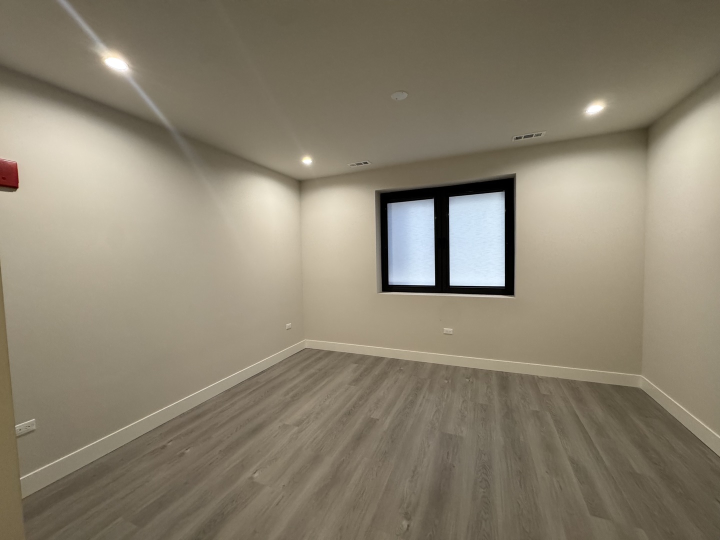 451 East Pershing Road, Unit 301 Chicago, IL 60653 - Photo 12 of 21 an empty room with wooden floor and windows