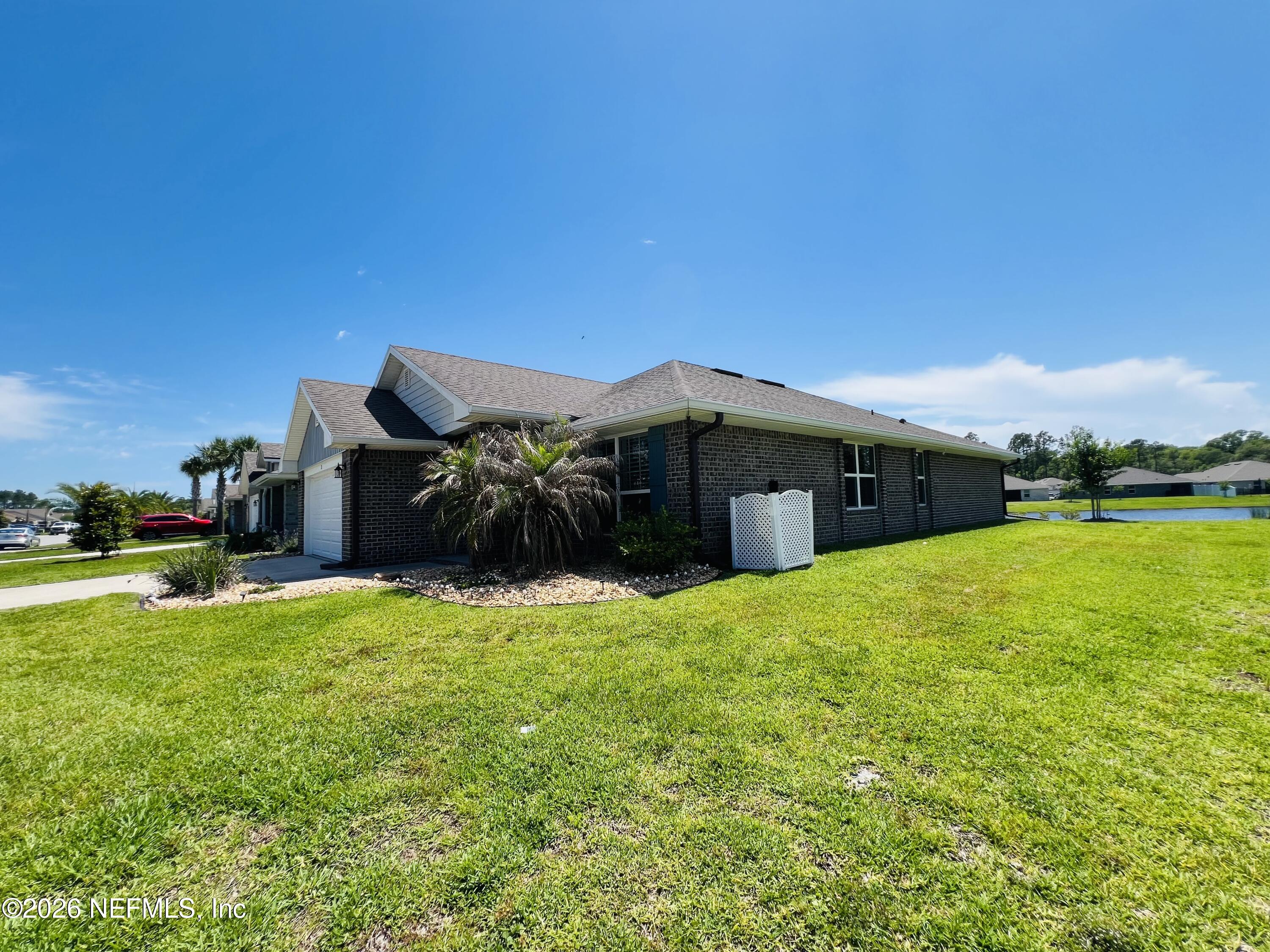 2 Rivertown Road Palm Coast, FL 32137 - Photo 13 of 80 a backyard of a house with yard and outdoor seating