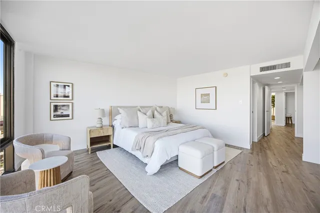 a spacious bedroom with a bed and a couch