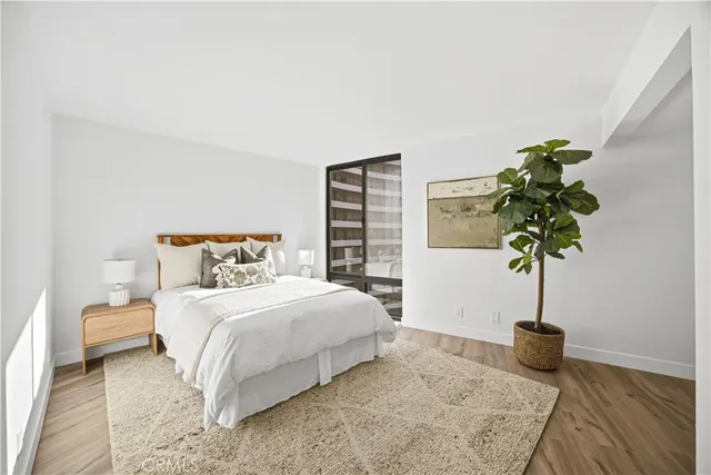 a bedroom with a bed potted plant and a potted plant