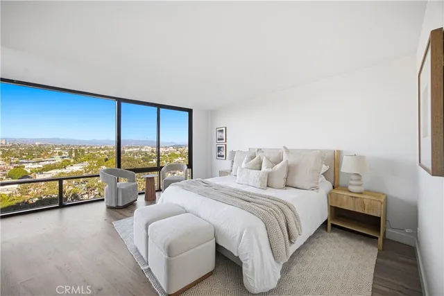 a spacious bedroom with a bed and a large window