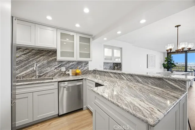 a kitchen with stainless steel appliances granite countertop refrigerator sink and cabinets