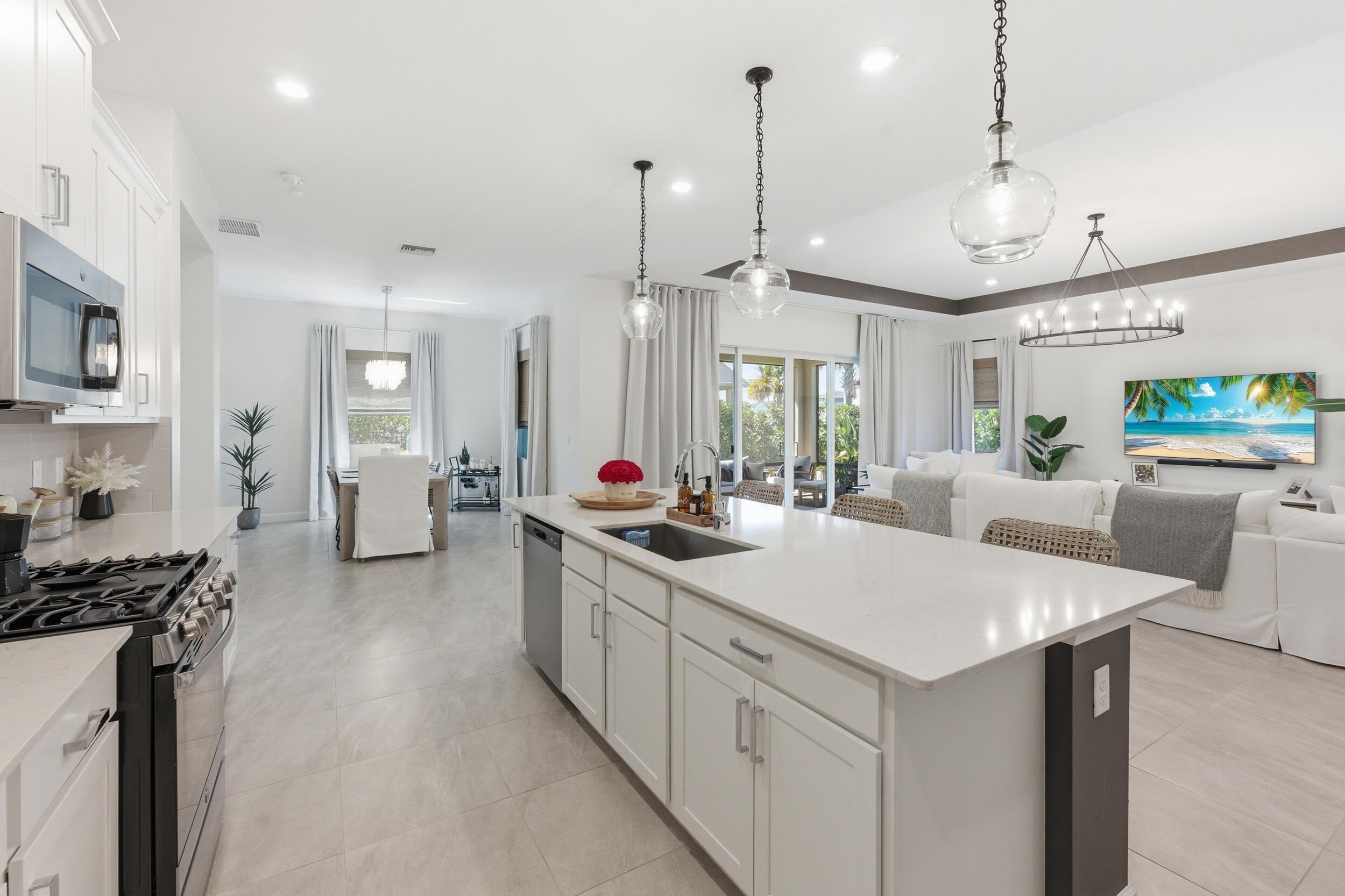 19230 Rolling Acres Road Loxahatchee, FL 33470 - Photo 19 of 58 a kitchen with stainless steel appliances granite countertop a sink a stove and a wooden floors